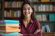 © Maryna - Portrait of a beautiful, smiling teacher. The woman stands near books, textbooks stack in classroom library. Education, teaching, learning, knowledge concept.