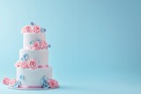 Three-tier wedding cake in rococo style with fondant icing on a soft pink and blue background.