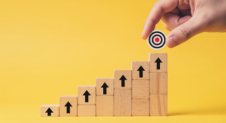 Poster - Wooden blocks forming an upward-pointing staircase, a target placed on top, symbolizing growth, achievement, and reaching goals