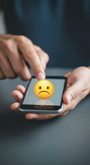 Aufkleber - Close-up of hands holding smartphone displaying unhappy emoticon, symbolizing negative feedback or dissatisfaction, showcasing digital communication issues