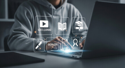 Poster - Person using a laptop with learning icons hovering above the keyboard in a digital environment