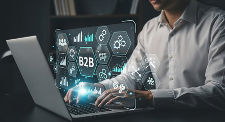 Poster - Man typing on laptop with b to b business icons and charts overlayed on the screen showing growth