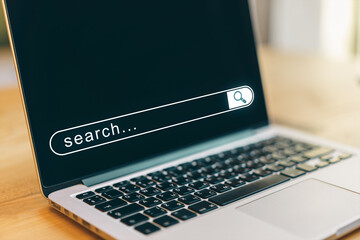 Poster - Closeup of laptop with digital search bar on screen in bright office setting, symbolizing online browsing and modern internet technology.