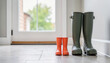 © Oksana - Adult and Child Rubber Boots by Door Ready for Outdoor Adventure