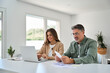 © insta_photos - Older man and woman paying bills online planning financial budget savings calculating payments sit at table. Middle aged mature couple using laptop counting taxes with receipts to save money at home.