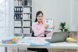 © Nittaya - Businesswoman Presenting Financial Data Online