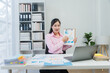 © Nittaya - Businesswoman Presenting Financial Data Online