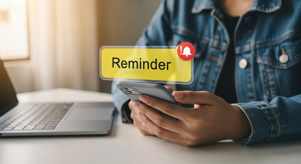 Poster - Person holding phone with reminder notification near laptop on a bright white surface indoors