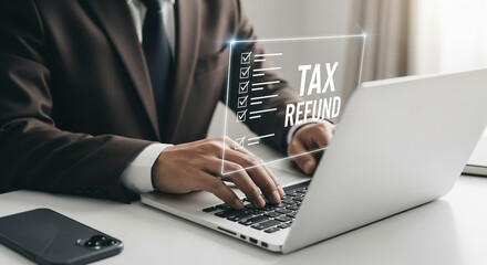 Poster - Man in suit types on laptop with tax refund graphic overlay and phone on white desk surface near him