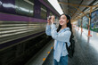 © PaeGAG - Asian traveler taking photos of a train at Hua Lamphong Station in Bangkok, Thailand