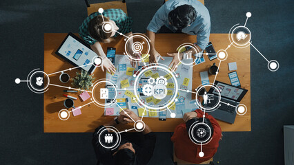 Poster - A dynamic team collaborates on KPI analysis and strategic planning at a bright workspace, surrounded by digital tools and engaging discussions for innovative solutions. Amity