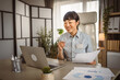 © Miljan Živković - Mature japanese woman hold document and read on laptop at office