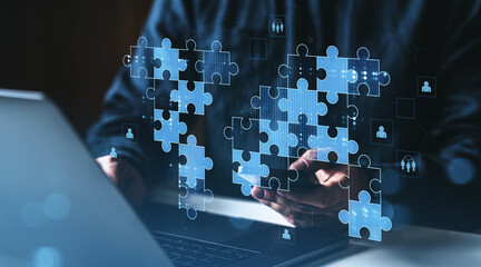 Poster - Digital teamwork concept with puzzle pieces representing collaboration and global success, floating above a laptop on a dark modern workspace background.