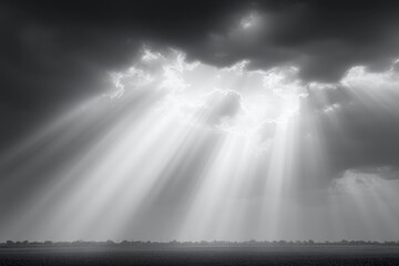 Wall Mural - sunbeams break through dark clouds, casting radiant light over a vast, flat landscape, evoking a dra