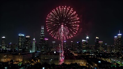 Wall Mural - fireworks in the sky over a city with a large crowd