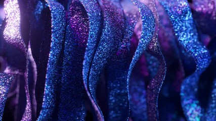 Poster - Shimmering blue and purple ribbons, covered in glitter, create a mesmerizing visual as they flow and undulate gracefully against a dark background