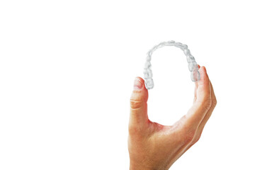 Aufkleber - Human hand showing clear dental aligner on clean white background, closeup layout for oral care and orthodontic health concept presentation