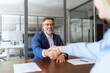 © Stock 4 You - Group of people satisfied with results of team work together, making handshake. Adult latin businessman man shaking hand with client, recruit female employee or business partner after signing contract