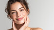 © @Amorea10 - Portrait of a smiling woman with clear skin, soft makeup, and a relaxed smile, against a light background. Background for concepts related to skin care, beauty, health, dermatology, cosmetic products.