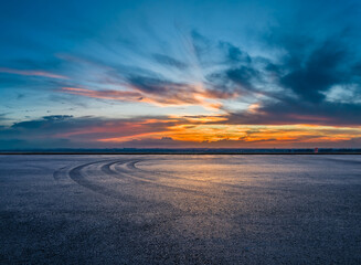 Wall Mural - empty asphalt road square and tire track with beautiful sky clouds at dusk