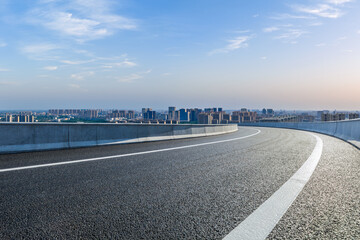 Wall Mural - asphalt highway road and city skyline with modern buildings under blue sky