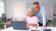 © snowing12 - Happy Asian Older Couple Enjoying Retirement Life at Home Using Laptop Together Senior Couple Communication Online Shopping and Relationship
