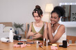 © Rakchanok - Beauty, skincare, wellness, comparison, multicultural, two young women with different skin tones posing together, smiling confidently, smooth skin tone difference for beauty influencer marketing