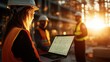 © svastix - A construction worker focuses on a laptop as the sun sets behind her, symbolizing the intersection of modern technology and traditional craftsmanship in construction.