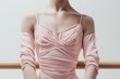 © nik_yurginson - Close up view of a ballerinas torso showcasing delicate details in a pastel leotard during a ballet practice session
