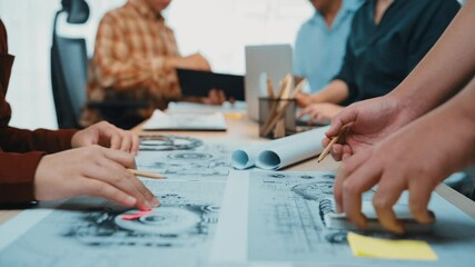 Poster - A dynamic office scene capturing a diverse group of professionals brainstorming creatively with sketches and documents spread across the table, fostering innovation. SACTR