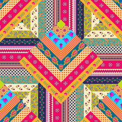 Wall Mural - Seamless zigzag patchwork pattern of multicolored stripes with floral and abstract ornament. Beautiful print for fabric in folk style.