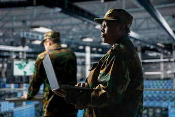 Poster - Soldier in server hub updating secure firmware on military data center hardware. African american army information technology expert in data center managing defense systems protocols