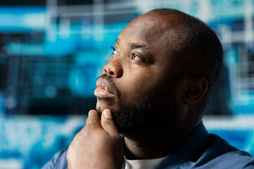 Poster - Black businessman using smart technology to interact with cybernetic platforms and AI interfaces, representing the integration of machine learning and predictive analytics in modern development.