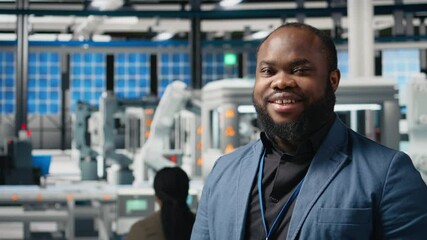 Poster - african american male engineer reviewing the production line activity at the facility, examining sol