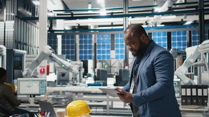Poster - african american industry expert reviewing photovoltaics assembly line, inspecting the production to