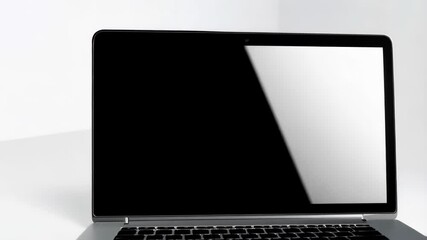 Fototapete - Silver portable computer on a white surface with a blank display, for showcasing web designs, applications, or software interfaces.