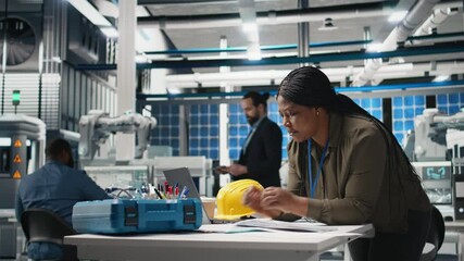 Poster - black engineering expert checking data on papers at the solar energy factory, conducting evaluations
