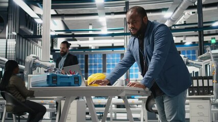 Poster - black master engineer reviews production line equipment for photovoltaics, working on alternative en