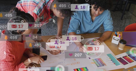 Poster - Collaborating professionals sketching UI mockups at table with smartphone, color swatches, markers