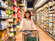 © Apichat - woman is shopping in a grocery store