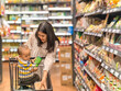 © Apichat - woman is shopping with her baby in a grocery store
