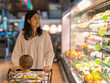© Apichat - woman and her child are shopping in a grocery store