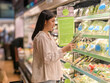 © Apichat - woman is shopping for vegetables in a grocery store