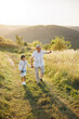 © prostooleh - Photo of a little boy with his grandfather walking in a field at summer