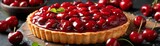 A luscious cherry tart on a wooden board, surrounded by scattered cherries. Sweet, red, and delectable