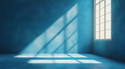 Poster - Empty blue room with light streaming through window showing abstract light patterns on wall and floor casting shadows creating serene interior space