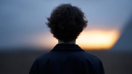 Poster - Curly hair person silhouette sunset outdoor, moody atmosphere, back view, solitude, dusk, peaceful