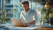 © ArtoryStock - Man Typing on a Windows 10 Laptop in a Modern Office   Tech and Productivity Concept