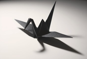 Poster - Minimalist black origami crane with striking shadows on a white background
