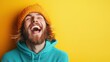 © Larisa AI - A joyful young man in an orange beanie bursts into laughter, radiating happiness and freedom against a vibrant yellow backdrop that exudes warmth and positive energy.